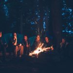 Group gathering around a bonfire.